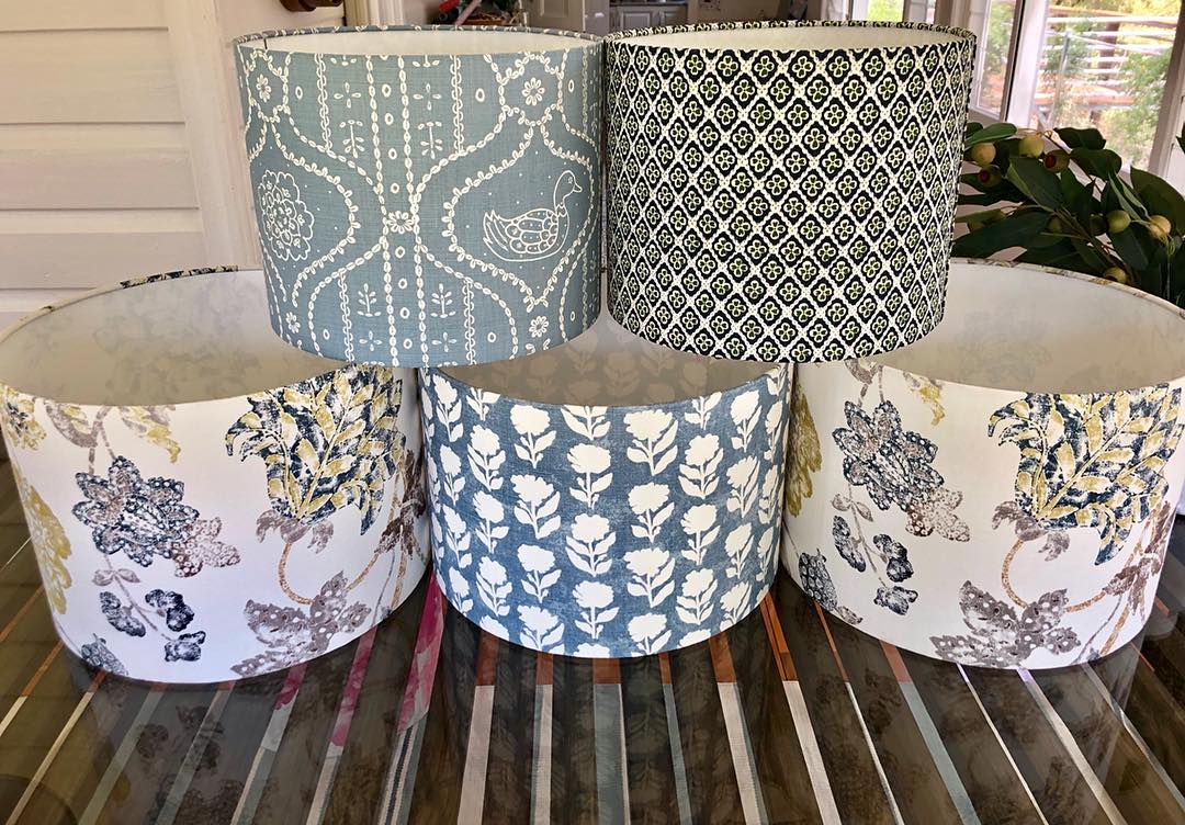 5 custom lampshade stacked on a restored wool table.