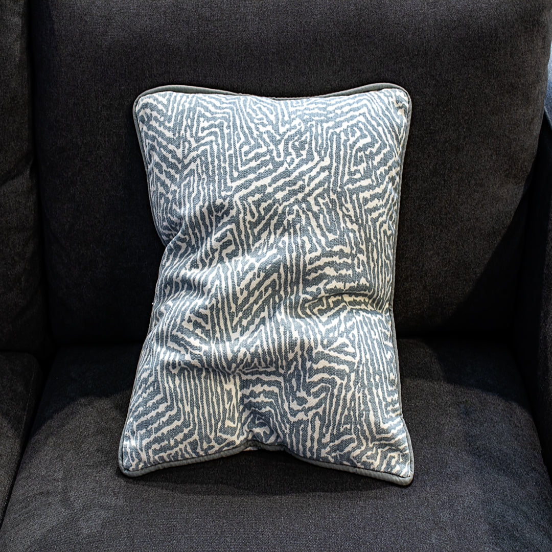 Decorative pillow with leaf pattern on a dark gray sofa - Fabric Woodyperry in blue by Schumacher from luxe and humble flipped side a romo fabric reversible.