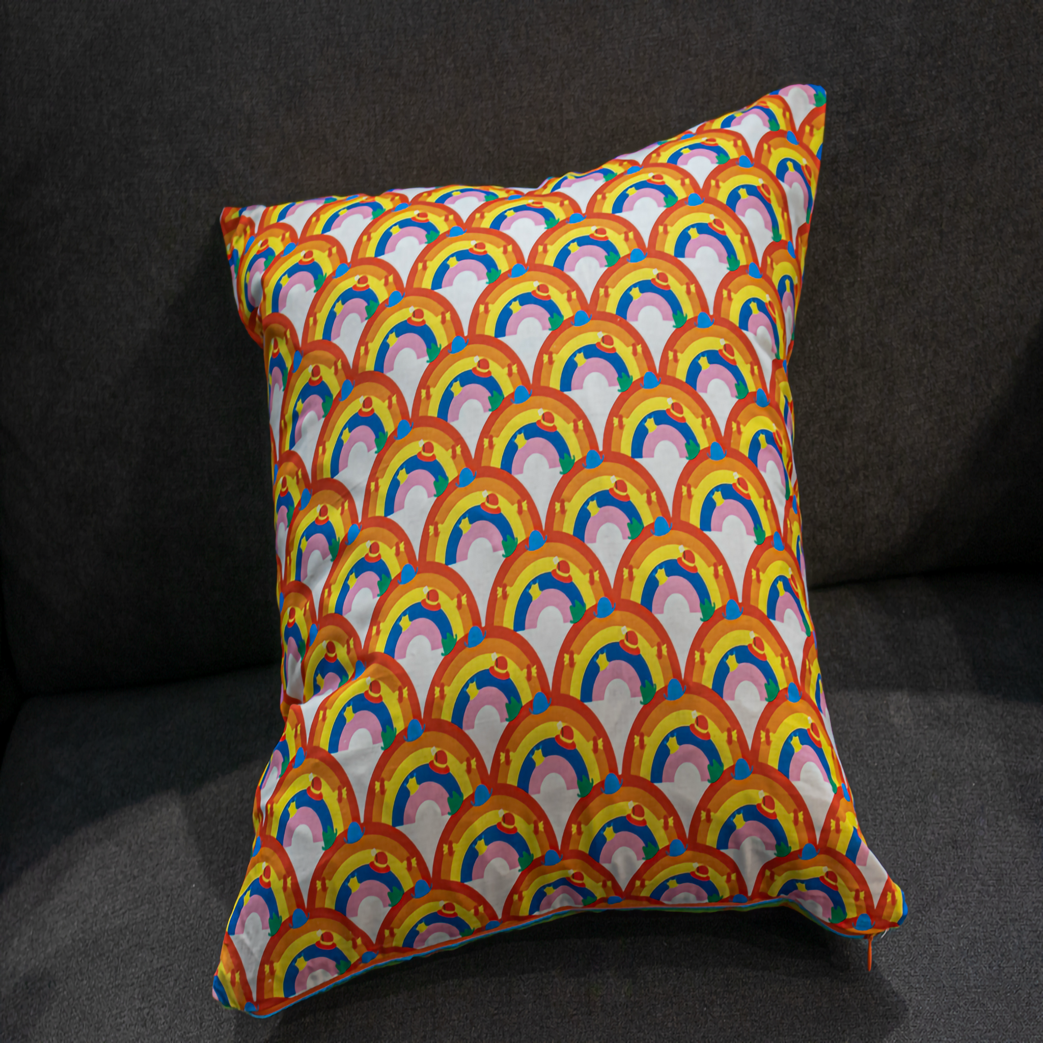 Reversible cushion featuring a bold rainbow arches design in vibrant orange, pink, blue, and yellow. This 50 x 50 cm pillow adds cheerful color and playful charm to any living room, bedroom, or kids’ space. Luxe & Humble exclusive.