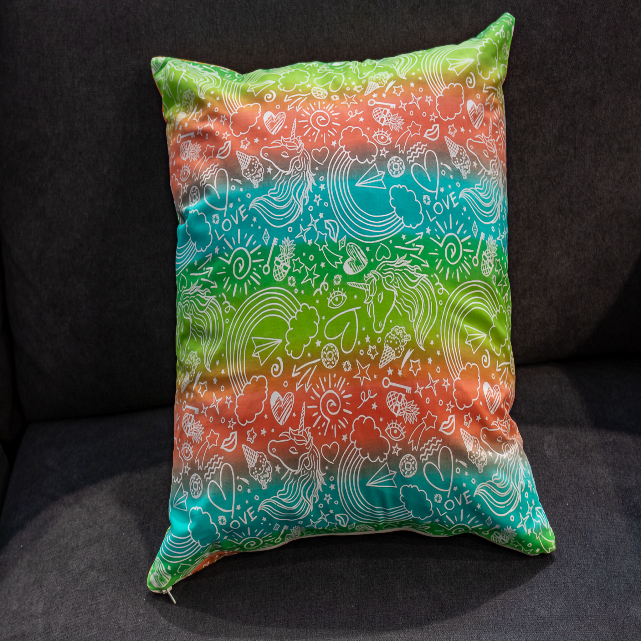 Rainbow pillow cover featuring unicorns, hearts, and playful doodles, adding a colorful and whimsical touch to your décor. Perfect for kids rooms!