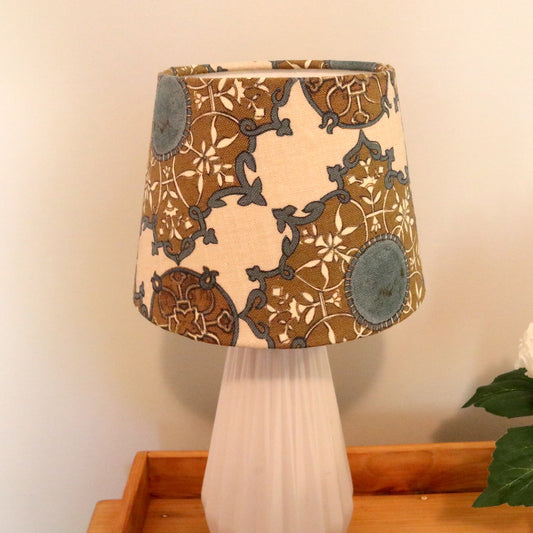 Nine Muses Fabric Small Empire Lampshade on a White Ceramic Lamp Base