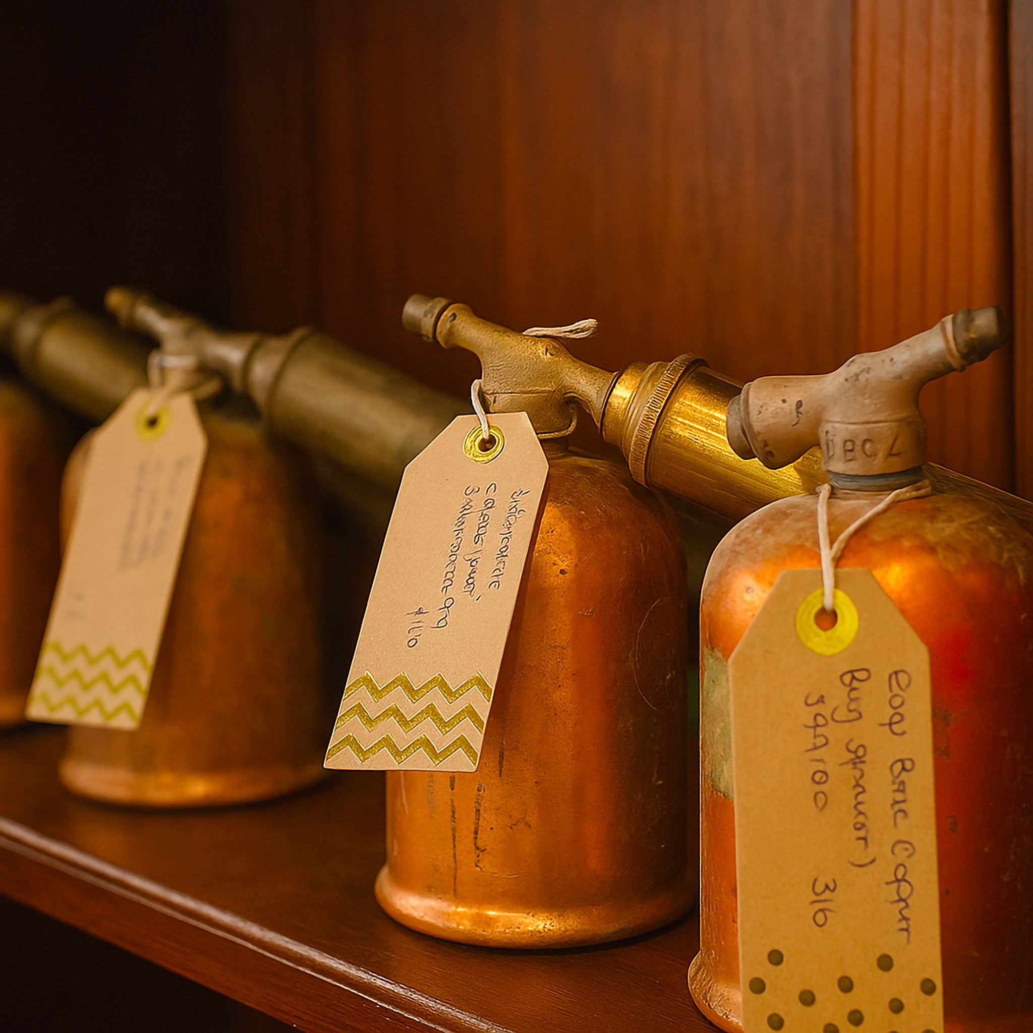 Rustic industrial vintage spray canister displayed on wooden surface