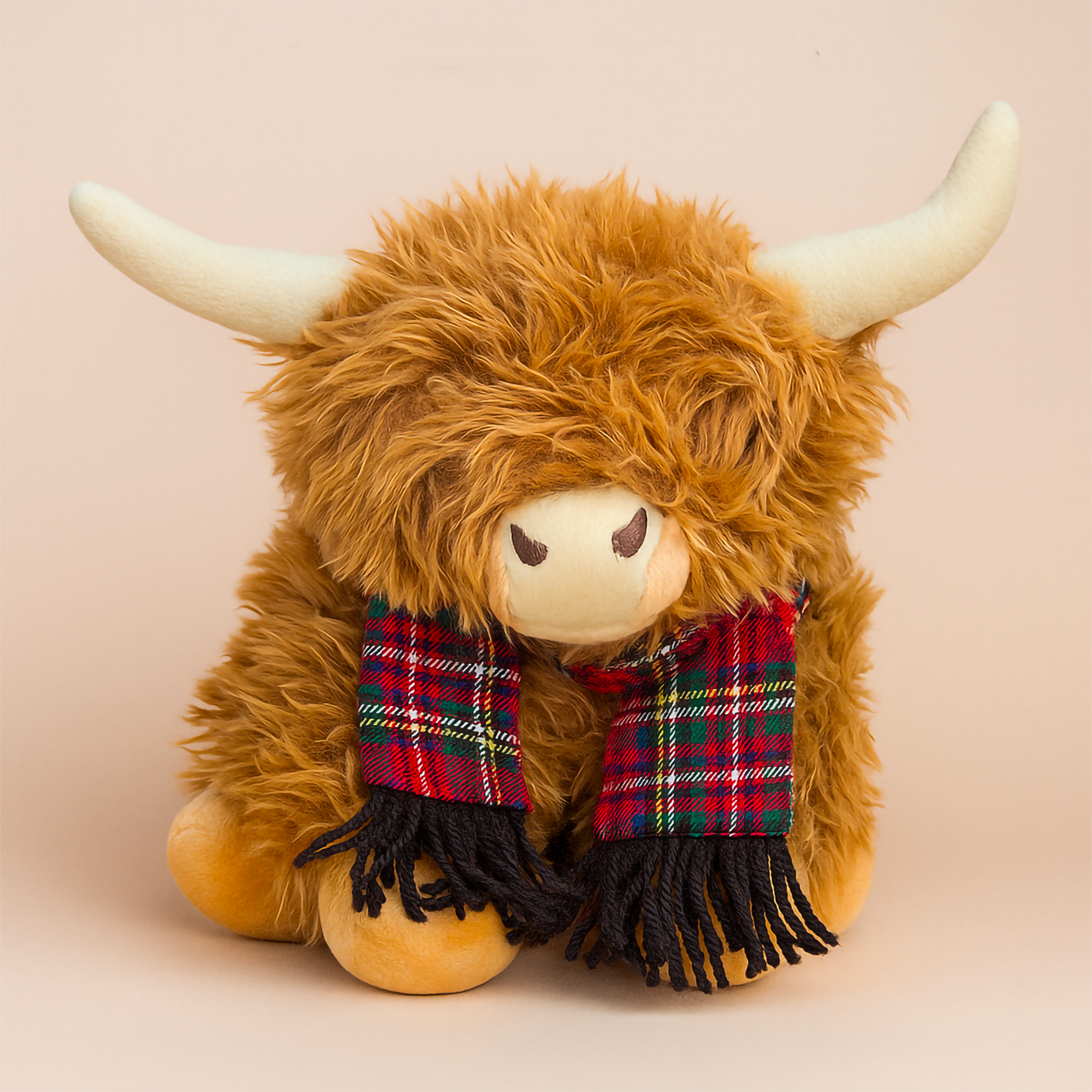 A 25cm brown Highland Cow plush toy featuring fluffy shaggy fur, soft tan horns and a traditional red tartan scarf, styled on a neutral studio backdrop. Adorable cuddly toy ideal for nursery décor, children’s gifts and farmhouse-inspired styling. Luxe & Humble Australia.