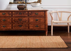 Wooden dresser and natural jute rug. 