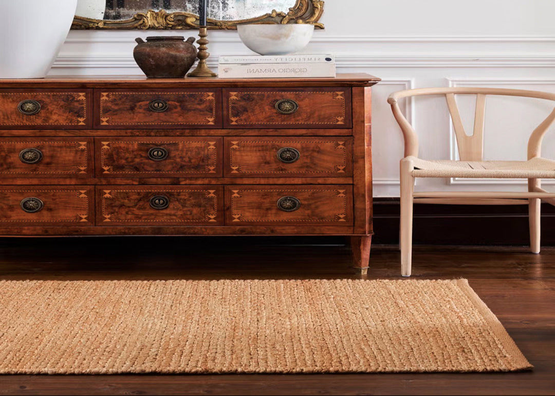Wooden dresser and natural jute rug. 