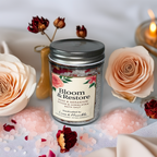Handcrafted in Australia, the Bloom & Restore Bath Salt by Luxe & Humble blends Epsom and Himalayan salts with rose petals and geranium for a soothing natural soak. Displayed beside blush roses, pink salts, and a lit candle for a calm, luxurious Australian wellness look.