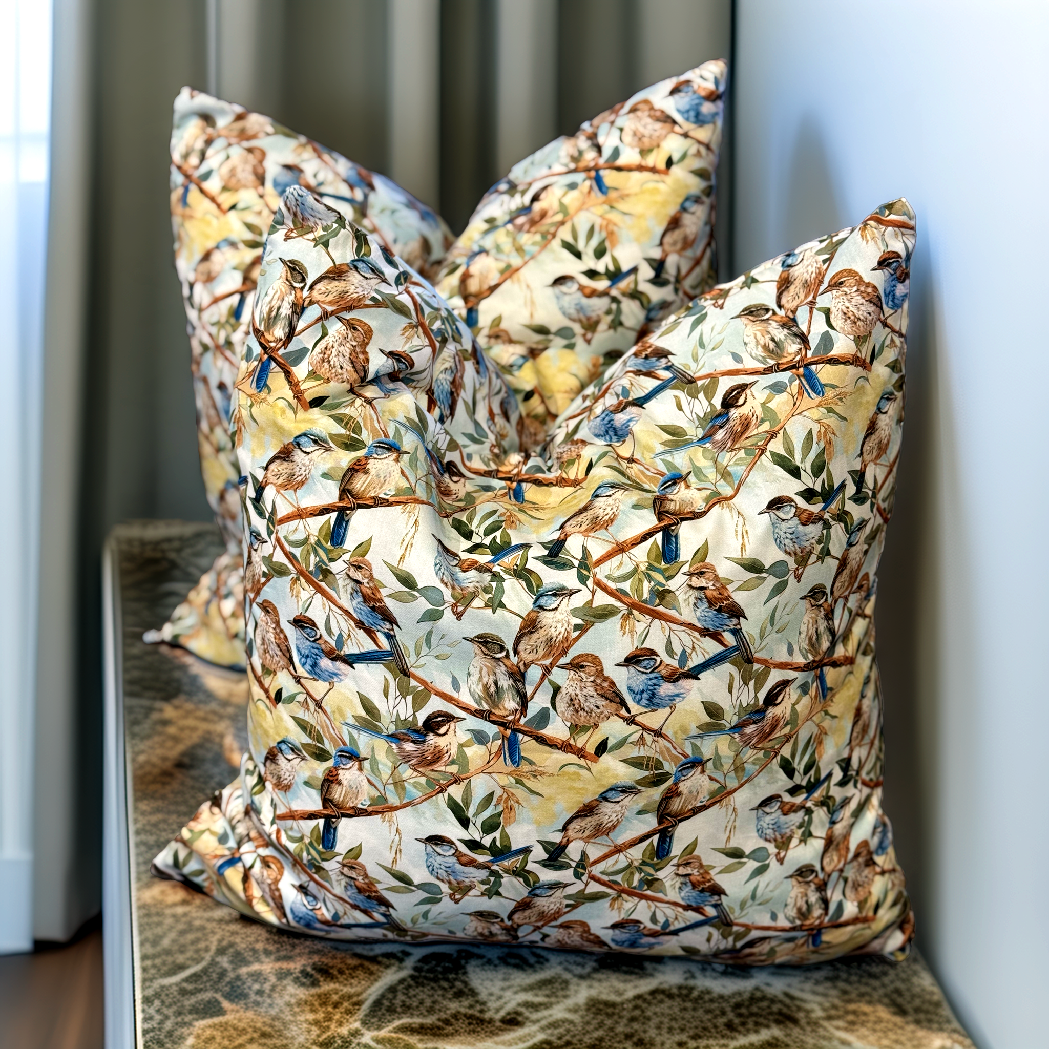 Handmade designer cushion featuring Blue Fairy-wrens perched among native branches. Luxe & Humble premium cushion with feather insert, available Australia-wide.