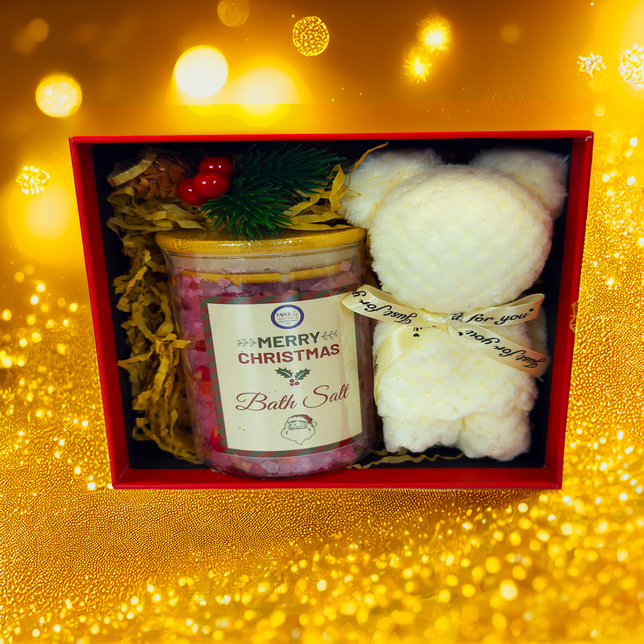 A Luxe & Humble Christmas gift box featuring a jar of festive bath salts with a “Merry Christmas” label and a soft white plush bear wrapped with ribbon. Styled with a glowing golden Christmas background, perfect for Australian holiday gifting, teacher gifts, Secret Santa and luxury self-care sets.