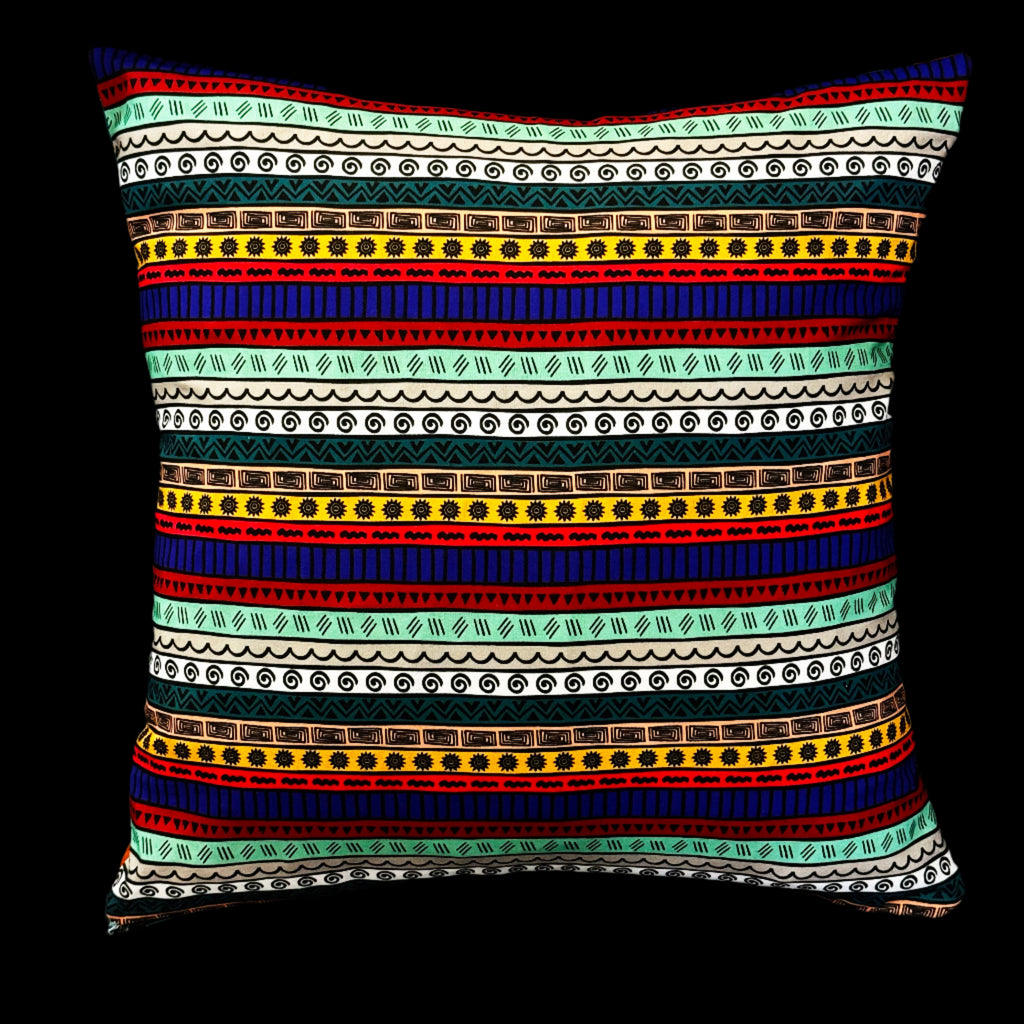Reversible pillow styled on dark sofa – Luxe & Humble tribal and playful interiors