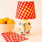 A handcrafted Fruit Motif Ceramic Lamp Base adorned with cherries, lemons, and strawberries, paired with a bold red gingham fabric lampshade. Designed by B.Bailey.Design.Co Australia, this playful yet timeless lamp captures modern nostalgia and artisan charm. Perfect for adding warmth, character, and colour to Australian homes.