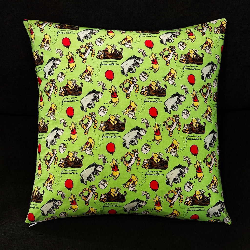 Winnie the Pooh reversible pillow featuring Pooh, Tigger, and Eeyore, with one side showcasing an inspirational quote and the other a playful balloon design, made from premium cotton fabric.