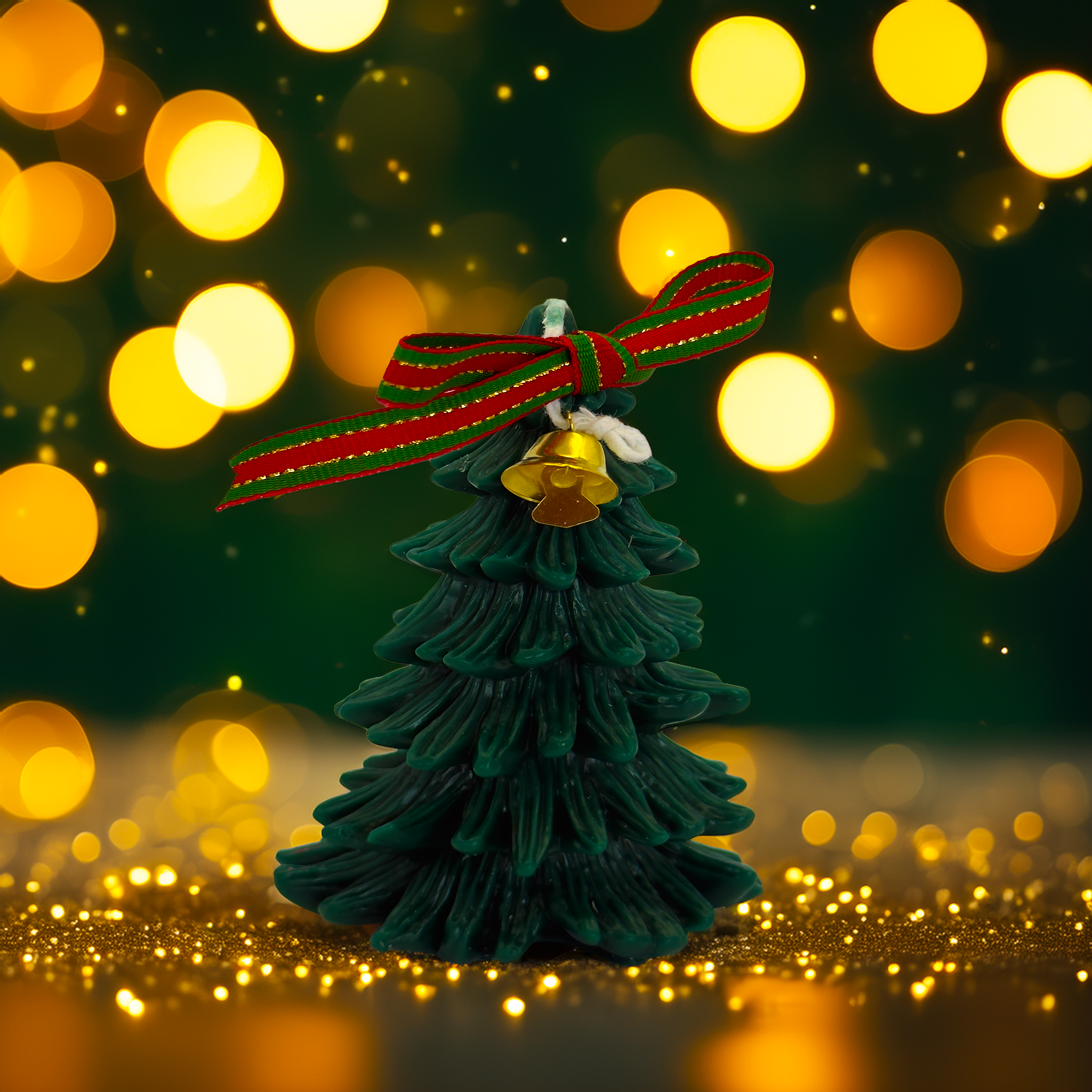Green Christmas tree candle decorated with a red and green ribbon and gold bell, photographed with warm festive bokeh lights. A luxury Christmas décor candle from Luxe & Humble, perfect for Australian Christmas gifting, hampers, and home styling.