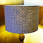 Lamp with a blue and yellow patterned shade on a blurred background