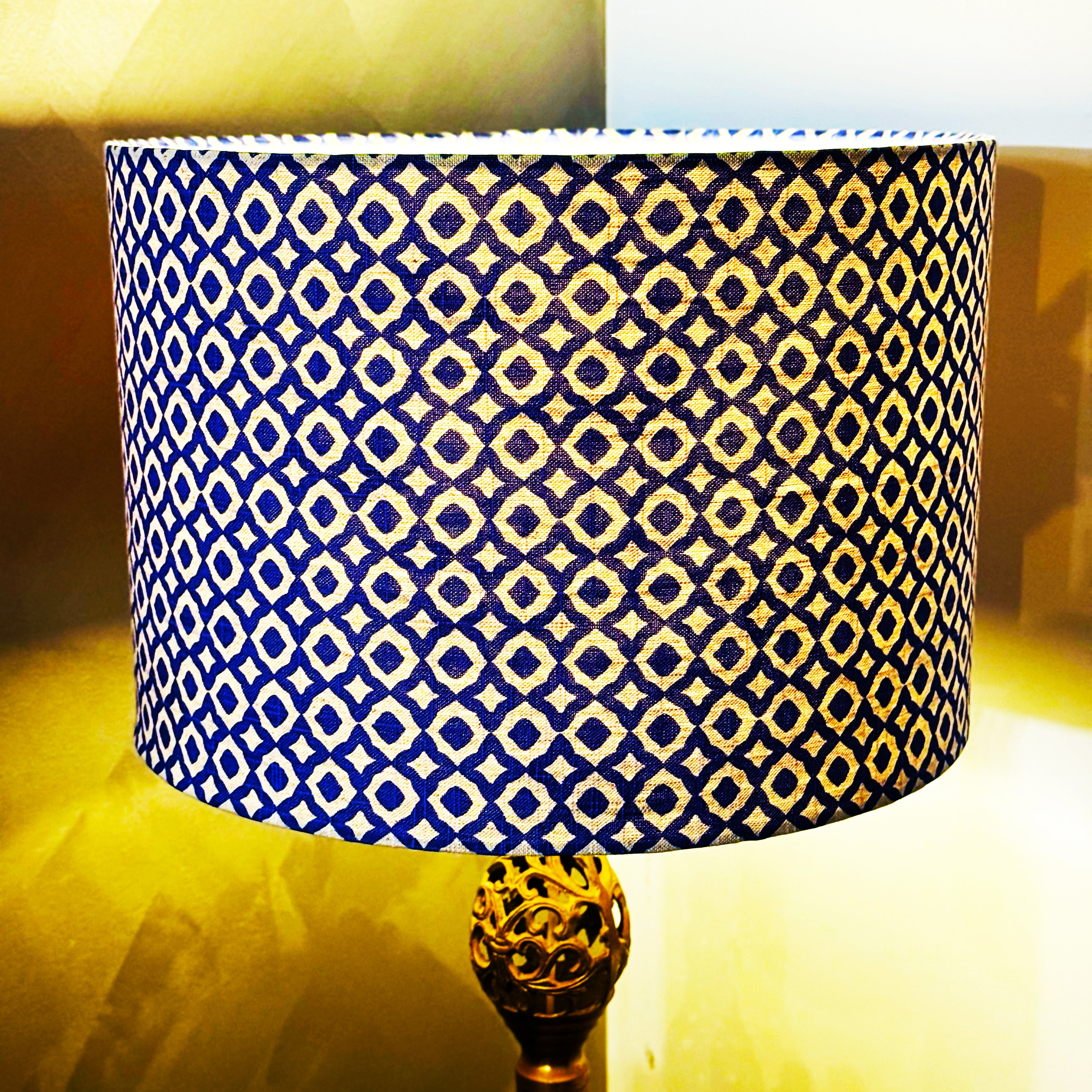 Lamp with a blue and yellow patterned shade on a blurred background