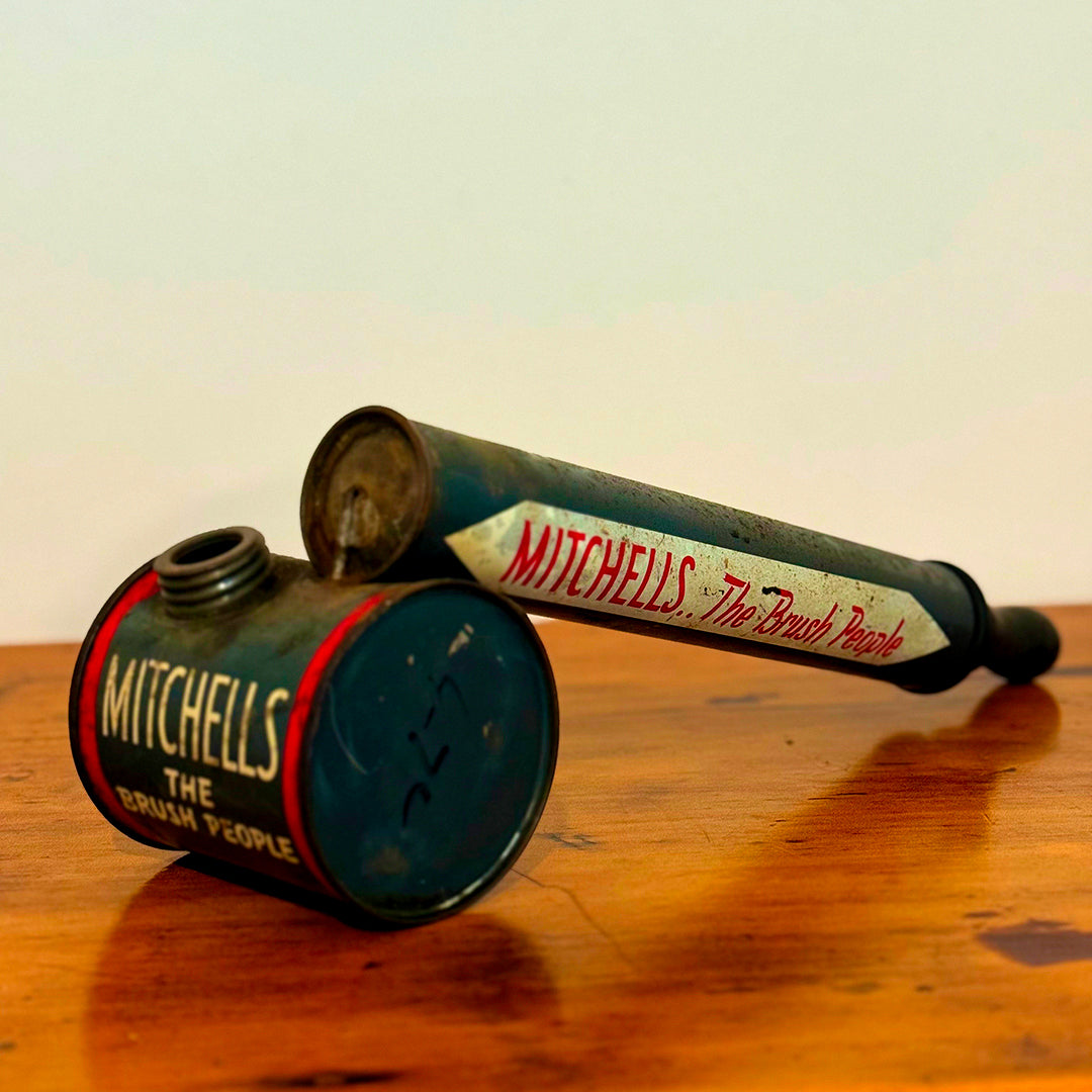 A close-up of a Vintage Mitchell’s Insect Spray canister in red and blue, marked with the iconic "Mitchell’s The Brush People" branding. The canister shows natural signs of wear, showcasing its vintage charm.