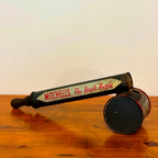 A close-up of a Vintage Mitchell’s Insect Spray canister in red and blue, marked with the iconic "Mitchell’s The Brush People" branding. The canister shows natural signs of wear, showcasing its vintage charm.