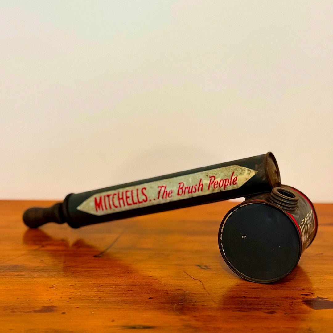 A close-up of a Vintage Mitchell’s Insect Spray canister in red and blue, marked with the iconic "Mitchell’s The Brush People" branding. The canister shows natural signs of wear, showcasing its vintage charm.