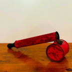 A close-up of a Vintage Red Insect Spray Can with a hand pump, featuring a distressed red finish. The can shows signs of wear, making it a unique and nostalgic collectible for any vintage collection.