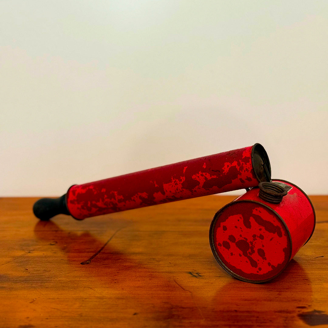 A close-up of a Vintage Red Insect Spray Can with a hand pump, featuring a distressed red finish. The can shows signs of wear, making it a unique and nostalgic collectible for any vintage collection.