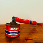 Vintage Lucky Sprayer with a red and blue design, showcasing a hand pump insecticide dispenser on a wooden surface.