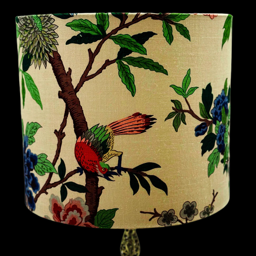 Decorative lampshade with floral and bird design on a beige background