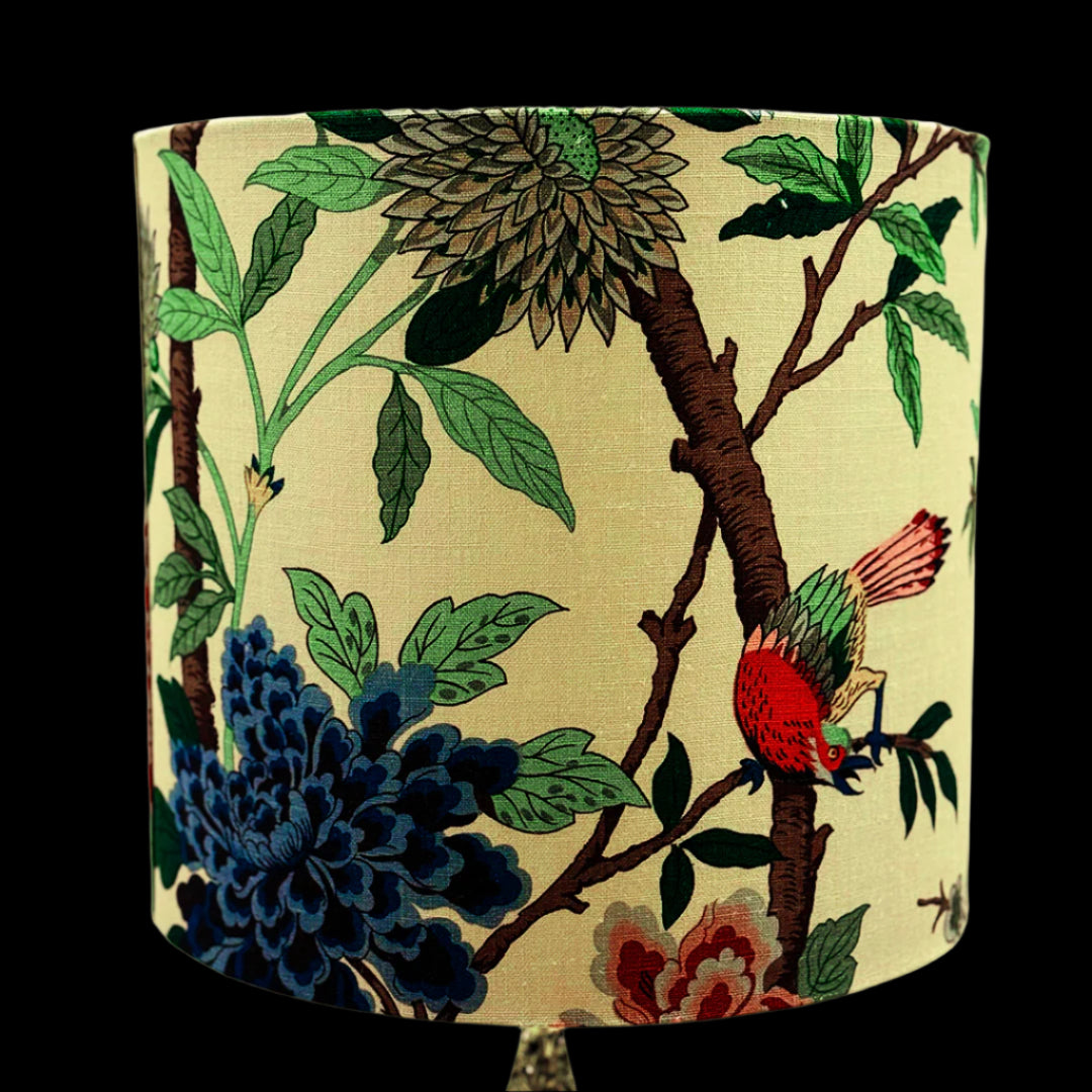 Decorative lampshade with floral and bird design on a beige background
