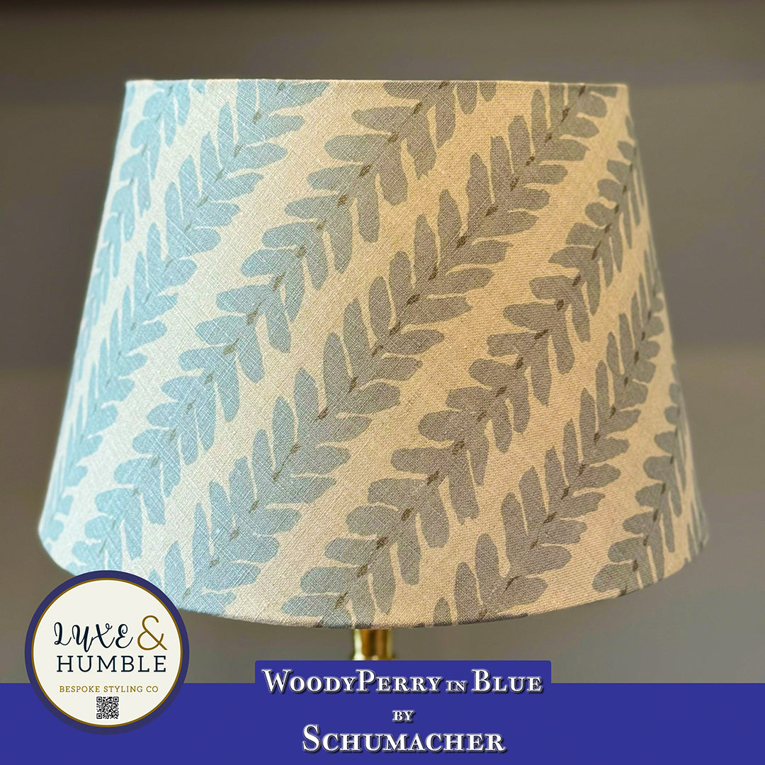 Lampshade with leaf pattern and Schumacher branding on a blurred background