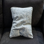 Decorative pillow with leaf pattern on a dark gray sofa - Fabric Woodyperry in blue by Schumacher from luxe and humble flipped side a romo fabric reversible.