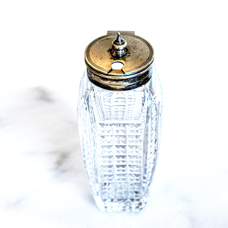 Cut glass and silver condiment bottle with silver lid