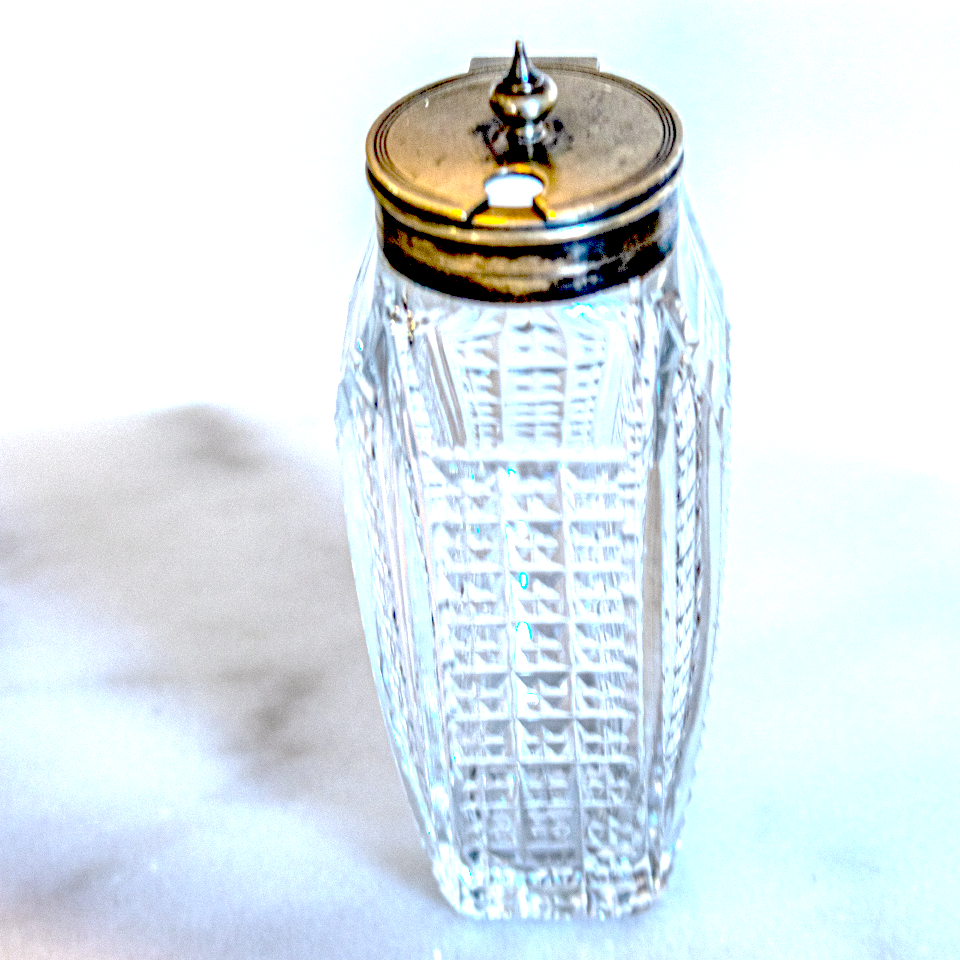 Cut glass and silver condiment bottle with silver lids