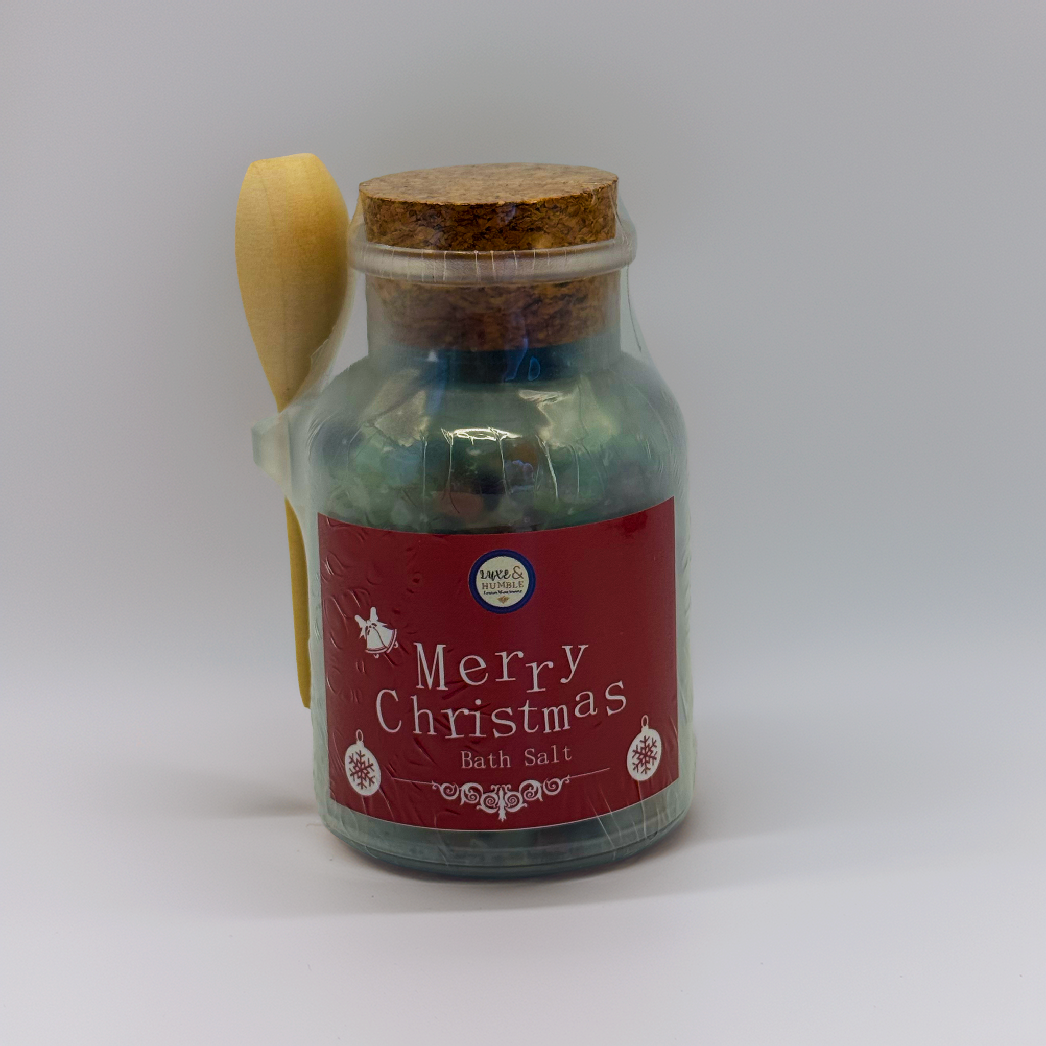 Red-label Merry Christmas Bath Salt presented in a vintage-style jar with cork lid and wooden spoon, displayed on a clean white studio background. Luxe & Humble handmade Christmas bath soak, perfect for gifting.
