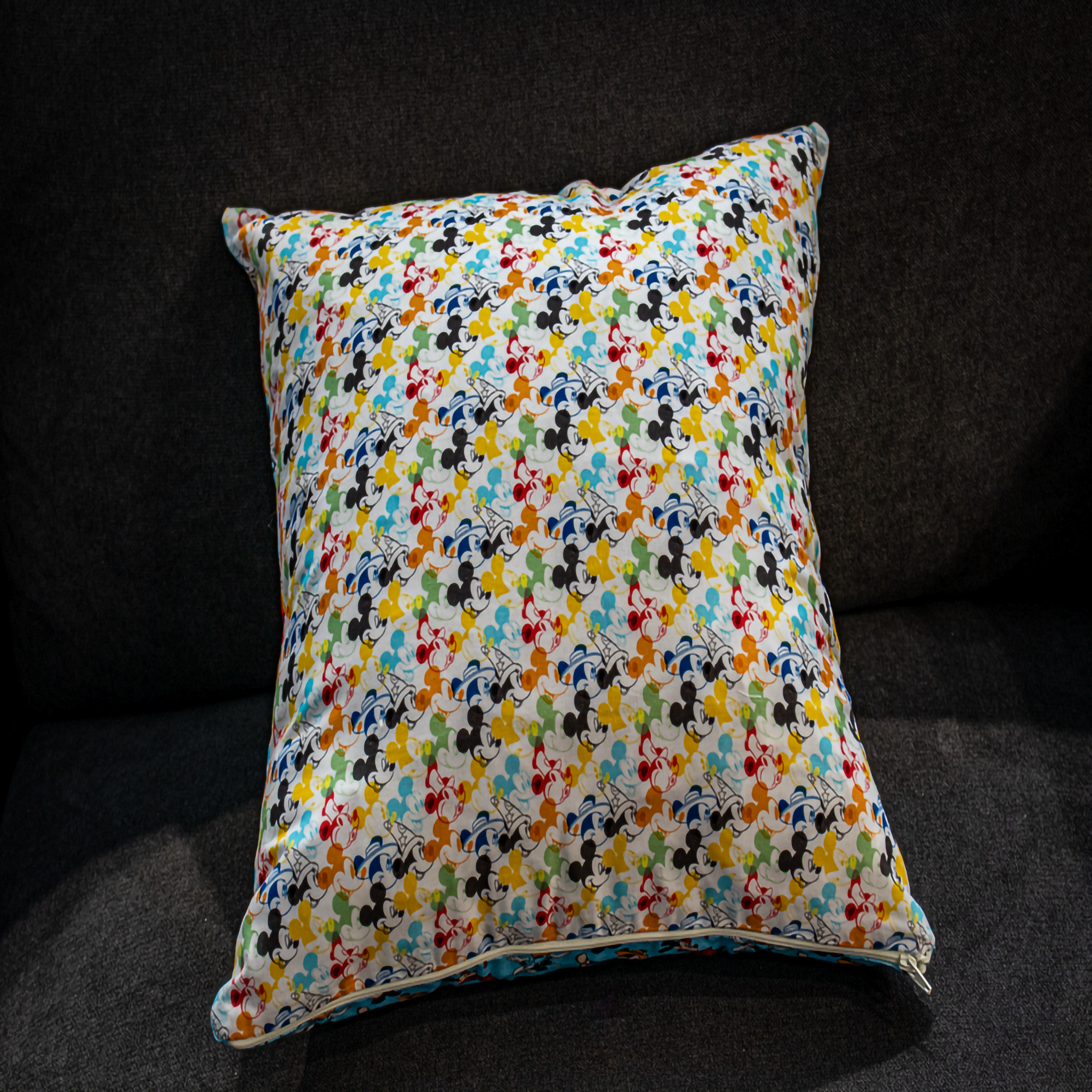 Reversible pillow featuring vibrant blue and white Mickey Mouse patterns, adding a playful and colorful touch to your home decor.
