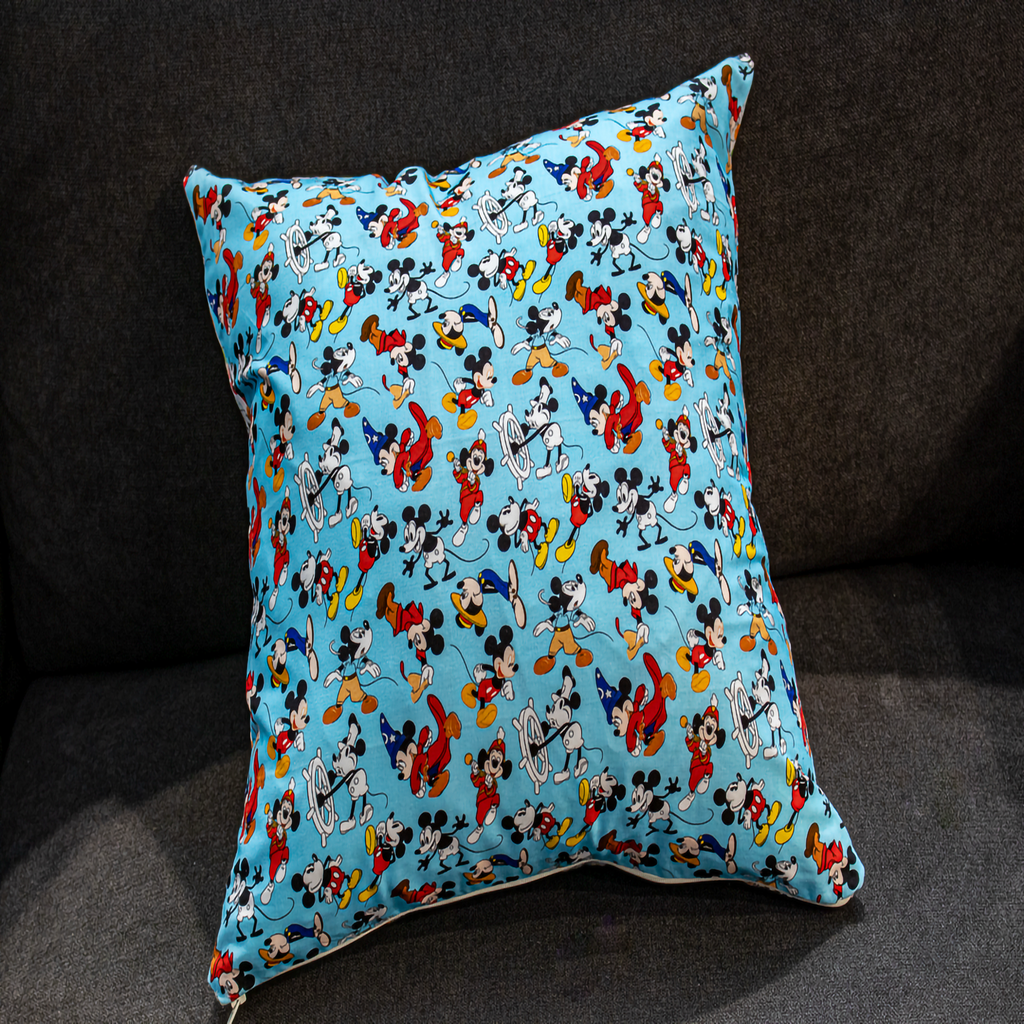 Reversible pillow featuring vibrant blue and white Mickey Mouse patterns, adding a playful and colorful touch to your home decor.
