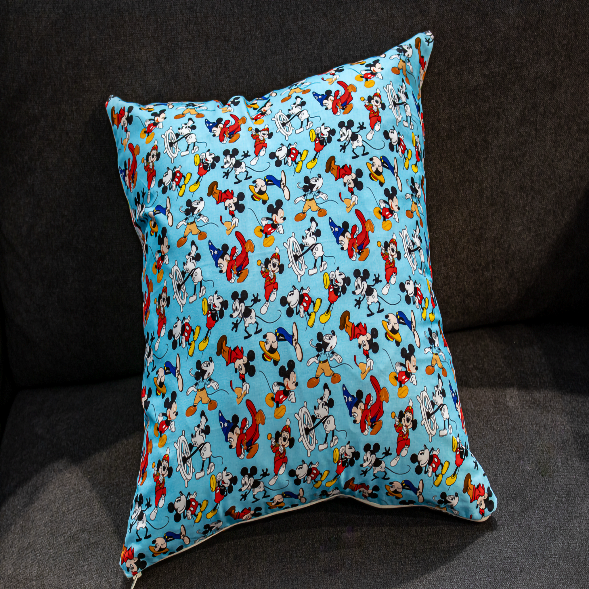 Reversible pillow featuring vibrant blue and white Mickey Mouse patterns, adding a playful and colorful touch to your home decor.
