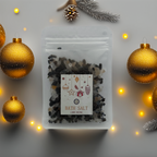 A Luxe & Humble Midnight Charcoal Christmas Bath Salt in a clear stand-up pouch filled with dark mineral bath salts. The festive Christmas label features ornaments, stars and a gift illustration. Minimal studio background highlights the handcrafted Australian holiday bath product, ideal for Christmas gifting and relaxation.