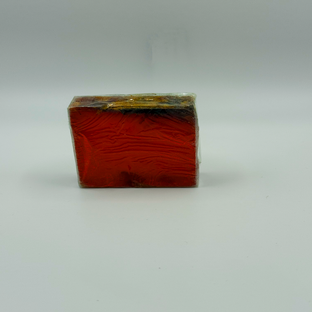 Handmade red-orange botanical soap bar with natural flower-infused top, photographed on a clean studio background – Luxe & Humble Australia.