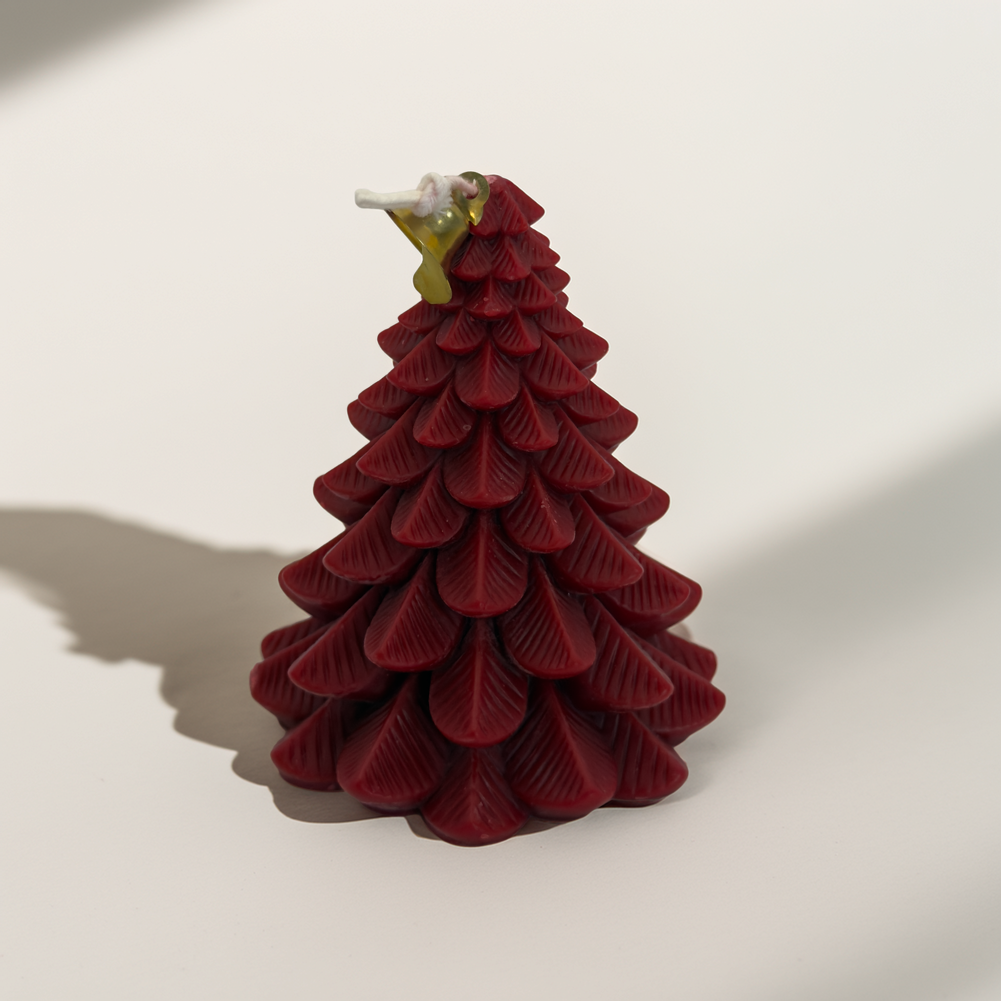 A detailed red Christmas tree candle photographed on a clean white background. Ideal for Shopify product listings, showcasing the candle’s sculpted layers and festive holiday design. Premium Christmas candle available Australia-wide from Luxe & Humble.
