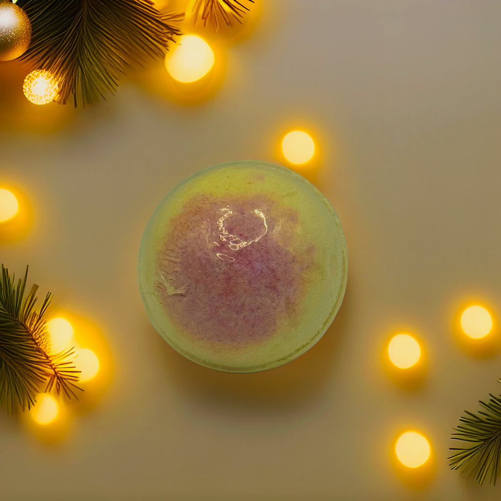 A soft yellow bath bomb with a pink rose-toned centre, photographed from above with glowing Christmas lights and pine sprigs. A handcrafted Australian bath bomb designed for gifting, floral lovers and holiday pampering.