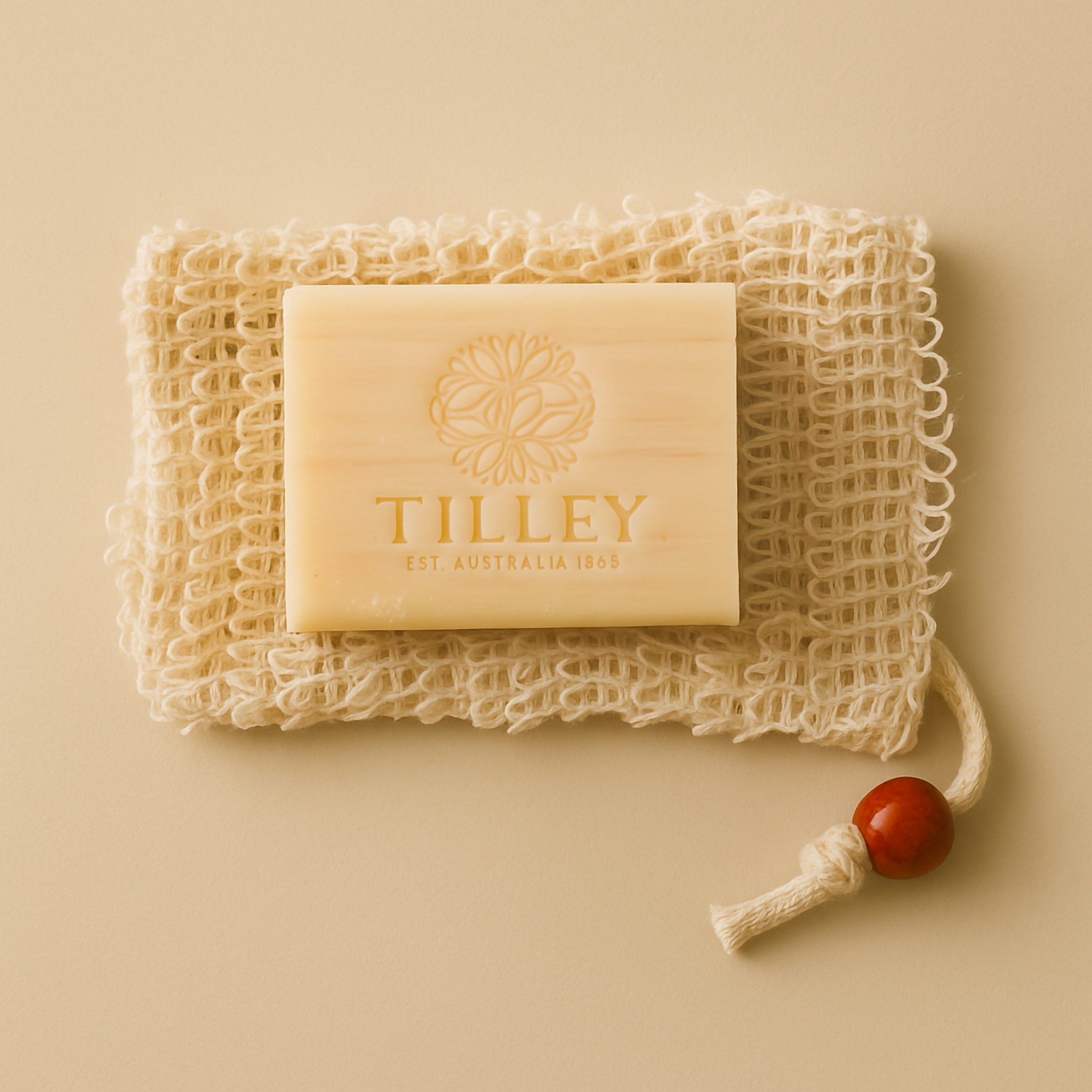 A handcrafted Purity Pouch exfoliating sisal soap bag paired with Tilley Goats Milk & Manuka Honey soap, styled on a neutral background to showcase its natural texture and eco-luxury appeal.
