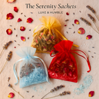 The Serenity Sachets by Luxe & Humble — handcrafted Australian organza pouches filled with dried lavender, rose buds, and coloured Epsom salts. Displayed in red, gold, and blue with scattered petals and lavender sprigs. Perfect for gifting, home, and car fragrance.