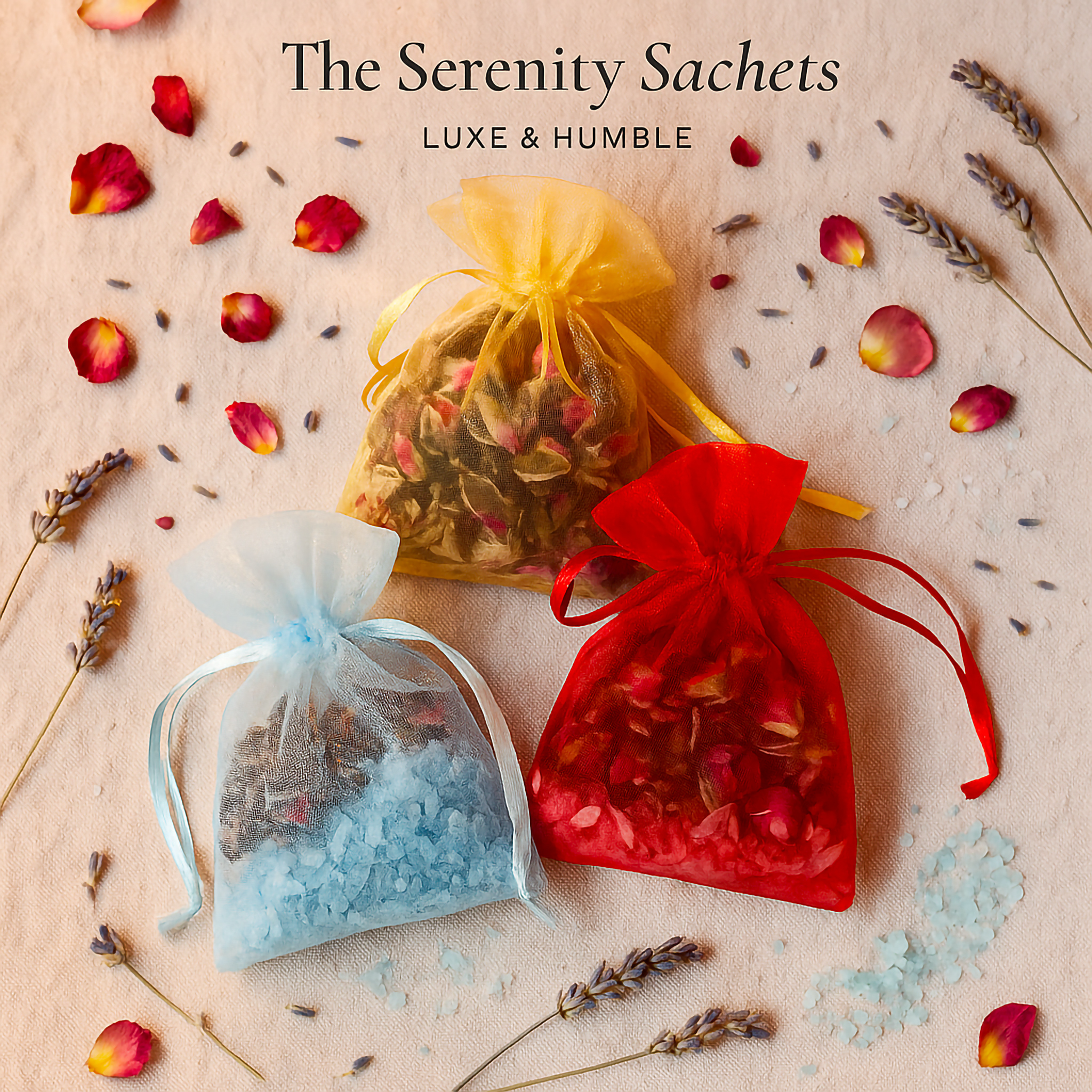 The Serenity Sachets by Luxe & Humble — handcrafted Australian organza pouches filled with dried lavender, rose buds, and coloured Epsom salts. Displayed in red, gold, and blue with scattered petals and lavender sprigs. Perfect for gifting, home, and car fragrance.