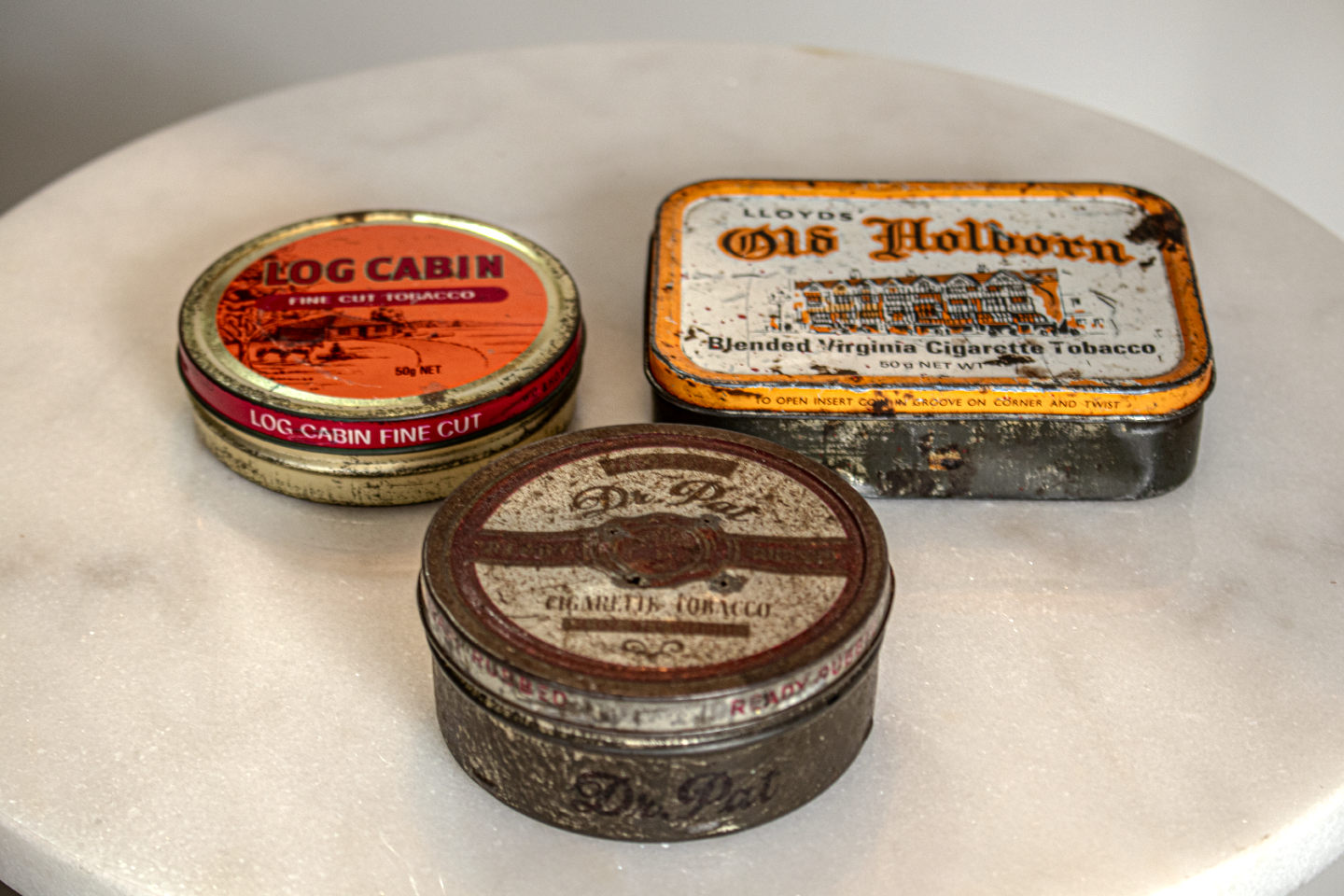 Various tobacco tins including a Dr Pat Cigarette Tobacco Tin at the front. 