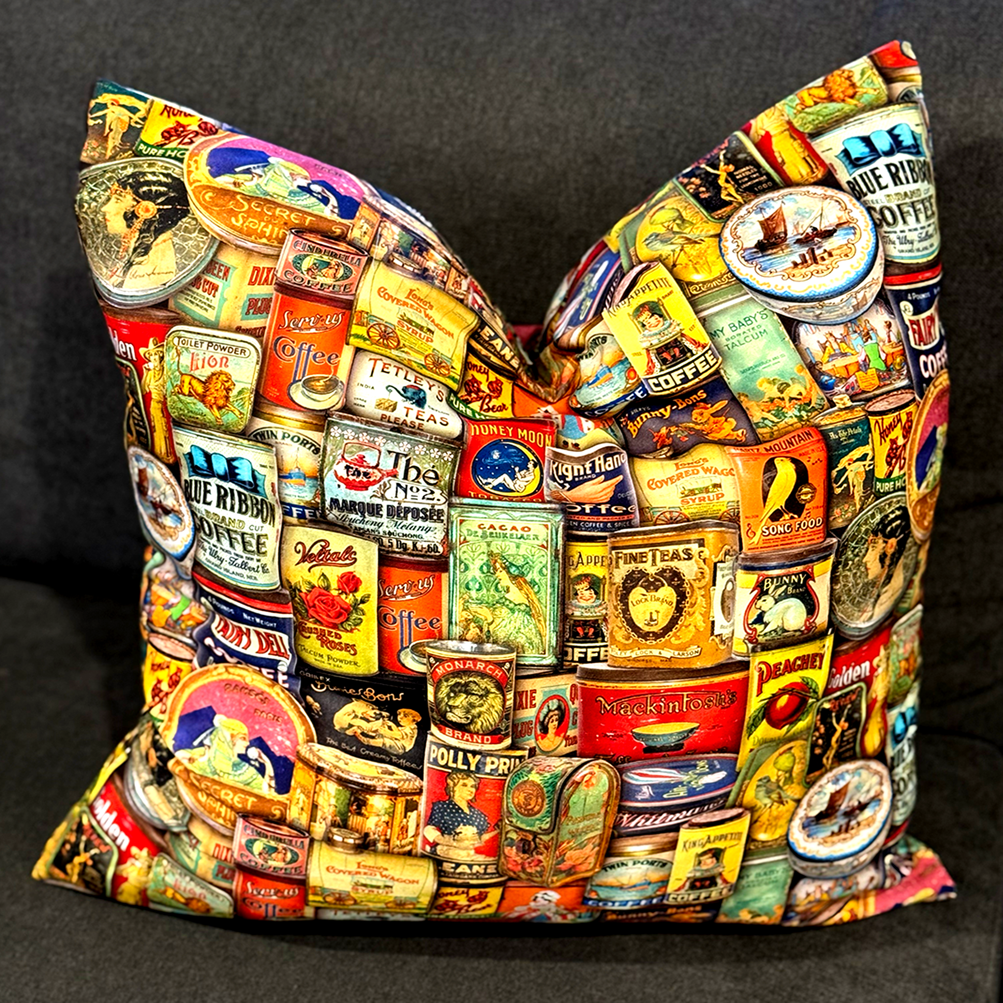 Handmade cushion featuring a colourful Vintage Tin Cans retro print with coffee, tea, and pantry labels. Luxe & Humble cushion with feather insert, available Australia-wide.