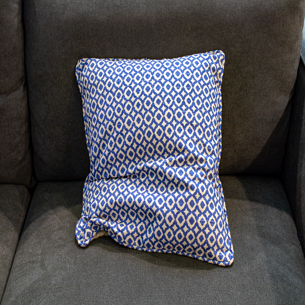 Reversible beige pillow cover with blue geometric piping, offering both a minimalist and stylish accent for your home décor.
