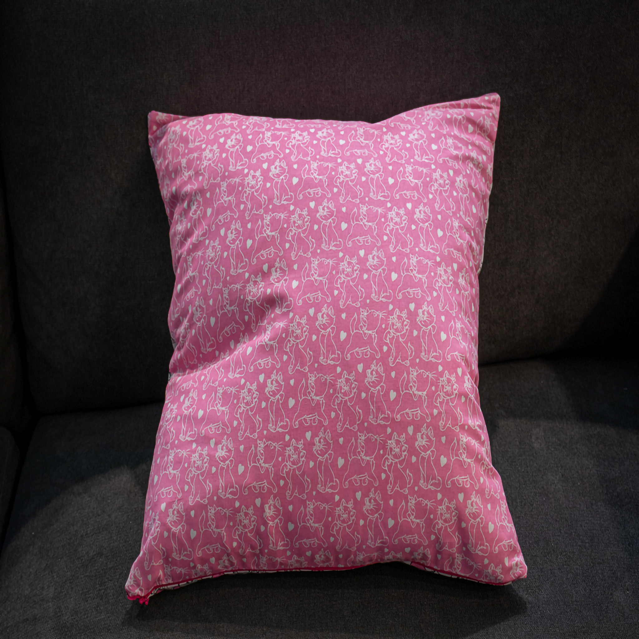 Fun pink pillow cover featuring a playful white cat print, adding a whimsical touch to your home décor. reversible 
