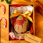 Handmade Luxe & Humble rustic Christmas bauble featuring red tartan and linen fabric with gold bow and reindeer motif in a festive gift box.