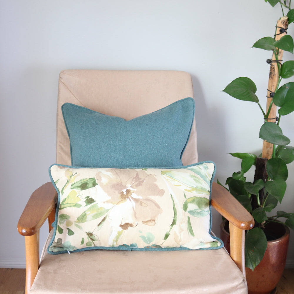 Beige, Green, Teal & Gold Floral Cushion with a green cushion