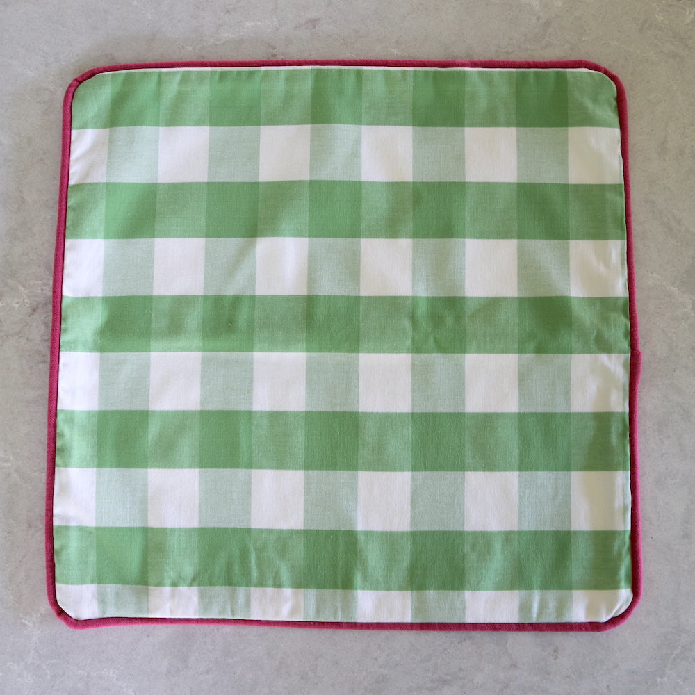 Green gingham cushion with fuchsia pink piping