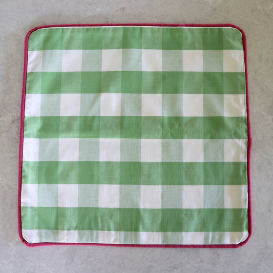 Green gingham cushion with fuchsia pink piping