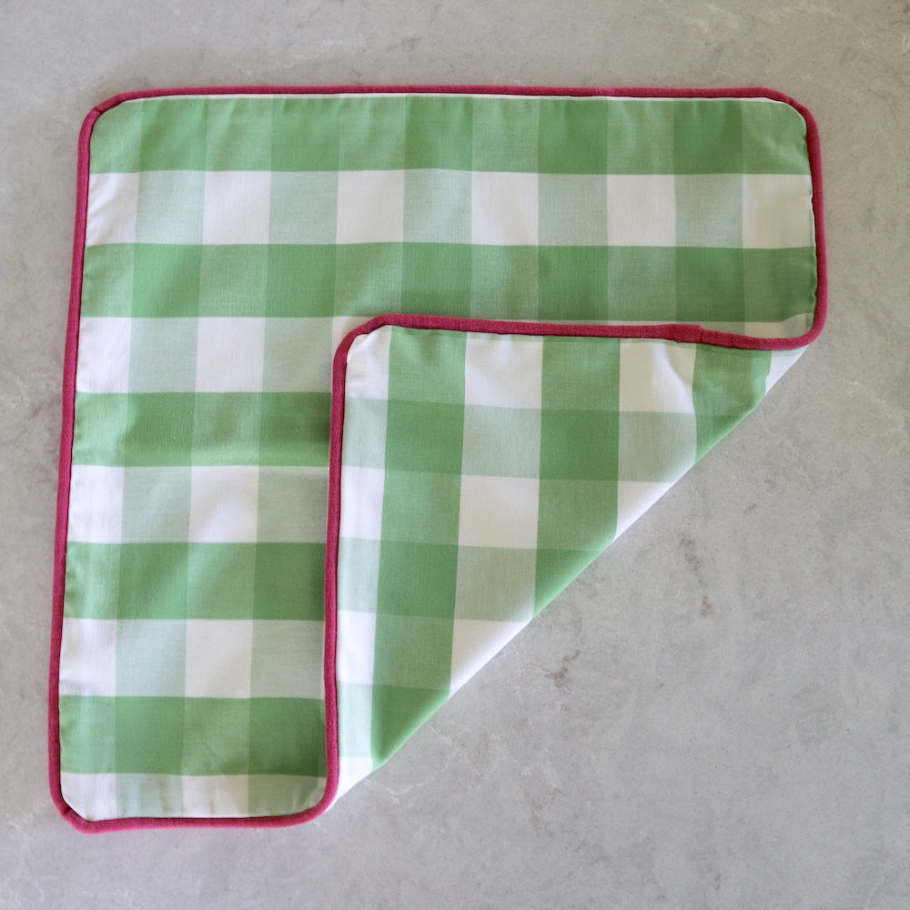 Green check cushion with fuchsia pink piping - front and back